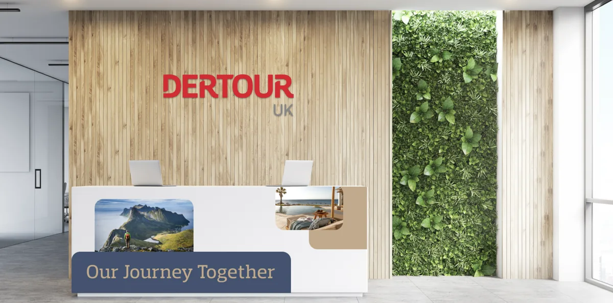 DerTour UK brand experience in a reception environment, the red wordmark on a timber wall beside a living-plant feature.